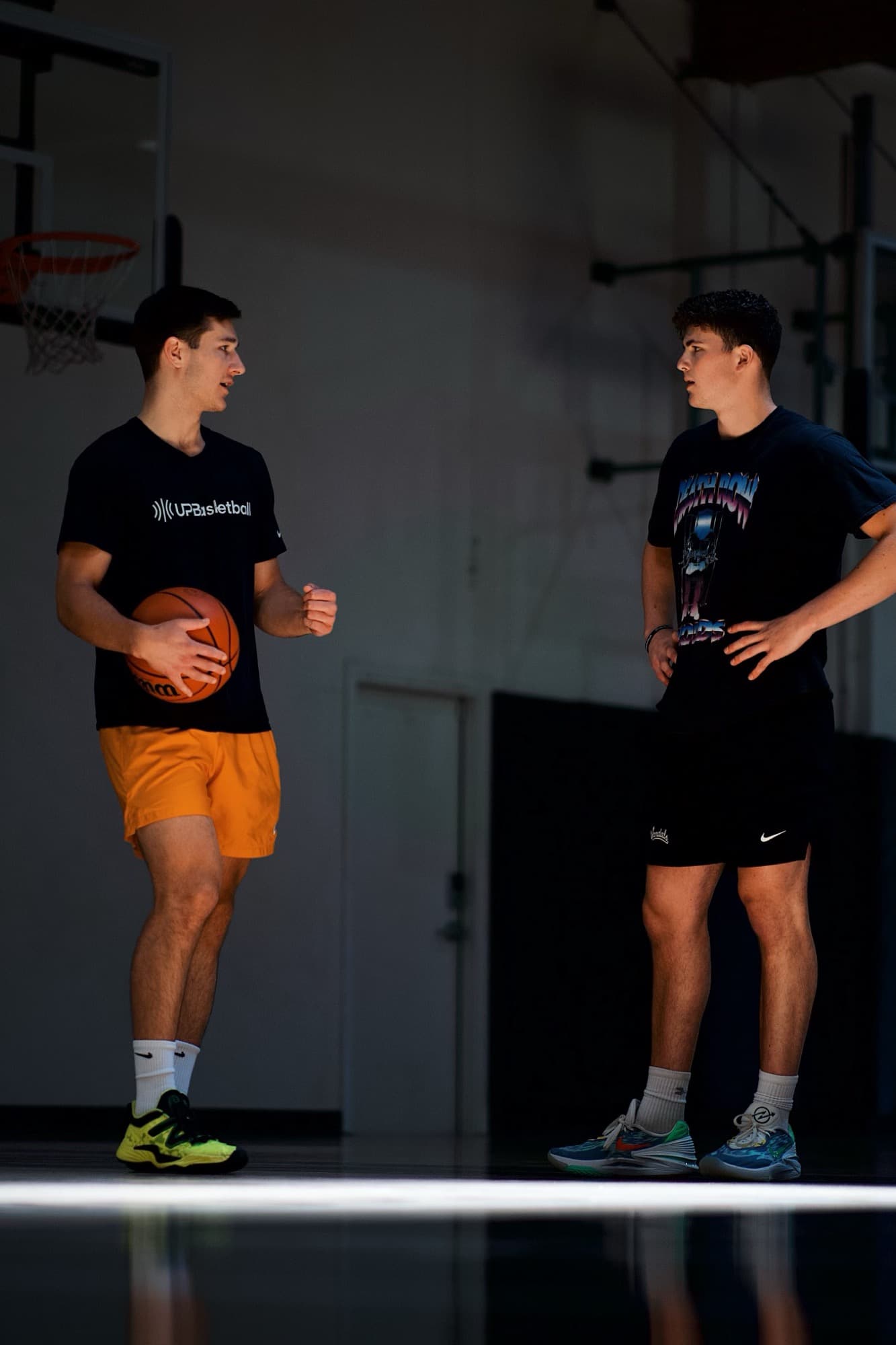 Joey Hewitt coaching an athlete on the basketball court