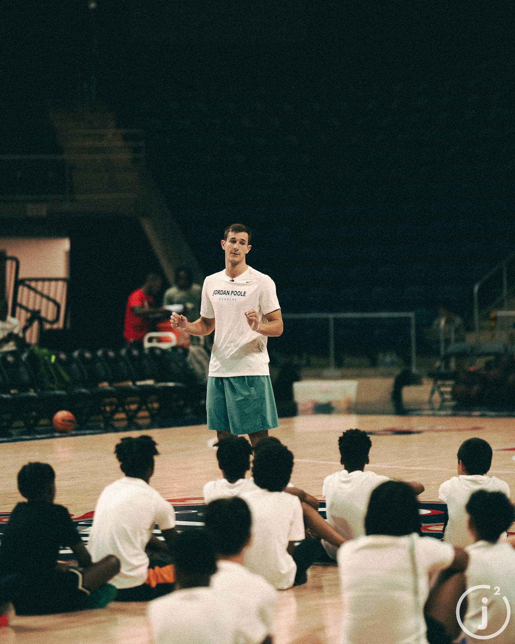 Joey Hewitt speaking to campers at Jordan Poole basketball camp
